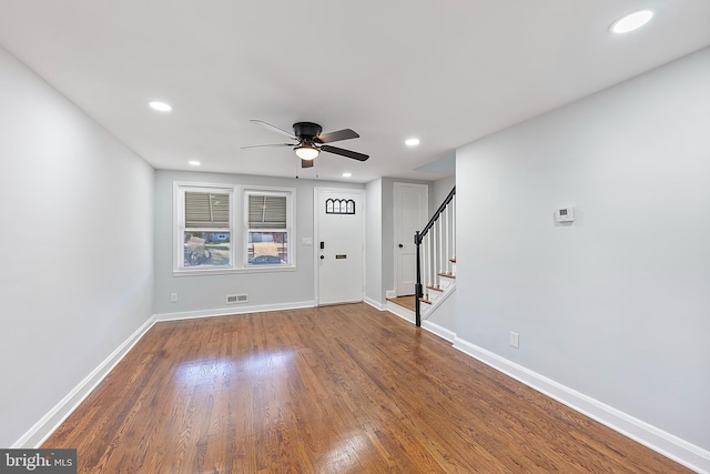 unfurnished living room with wood-type flooring and ceiling fan