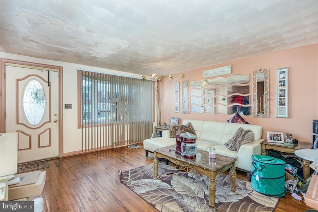 living room with hardwood / wood-style flooring and a textured ceiling