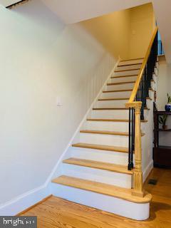 stairs with hardwood / wood-style flooring