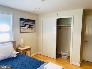 bedroom featuring light hardwood / wood-style floors and a closet