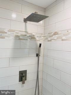 bathroom with a tile shower