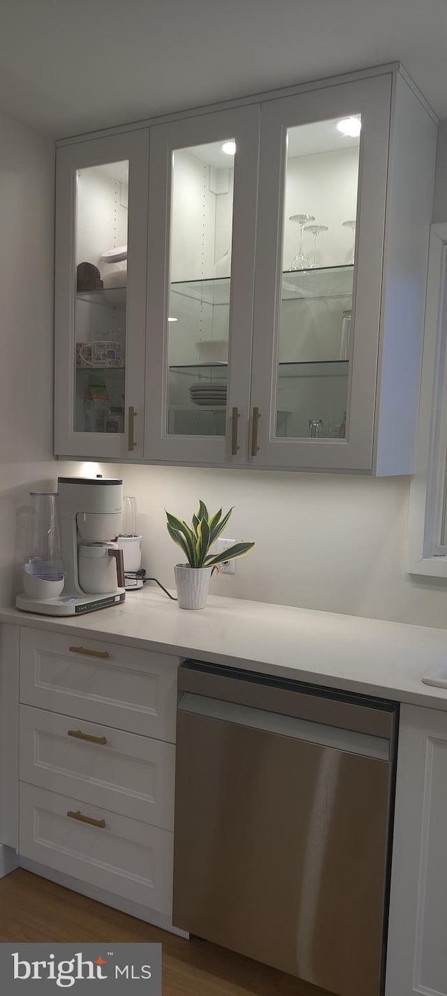 bar with dishwasher and white cabinets