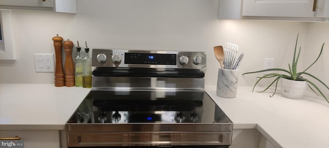 interior details with stainless steel range with electric cooktop