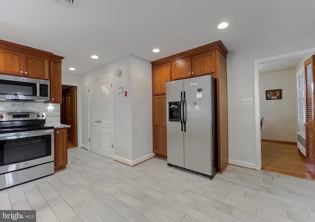 5425 Indian Head Hwy, Indian Head, MD 20640 - kitchen featuring appliances with stainless steel finishes, backsplash, and light wood-type flooring