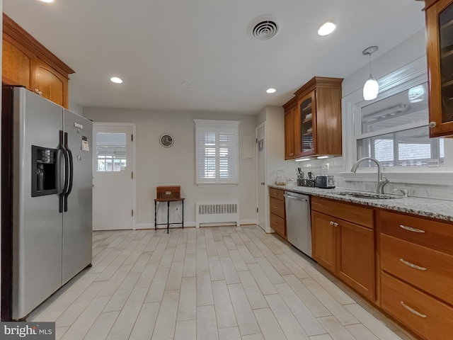 5425 Indian Head Hwy, Indian Head, MD 20640 - kitchen with sink, hanging light fixtures, appliances with stainless steel finishes, radiator, and light stone countertops