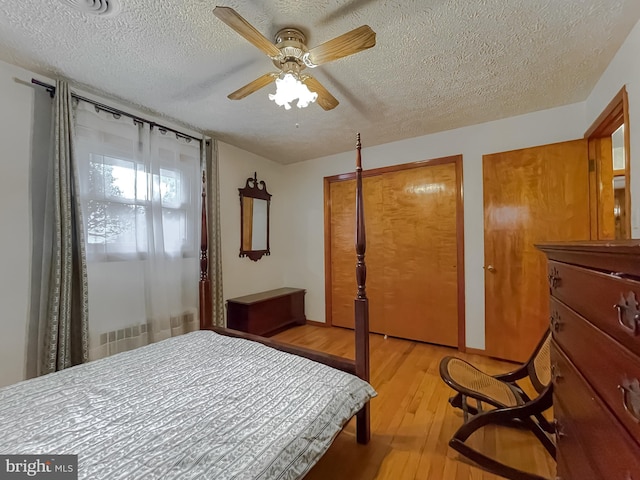 5425 Indian Head Hwy, Indian Head, MD 20640 - bedroom with multiple closets, ceiling fan, a textured ceiling, and light hardwood / wood-style flooring