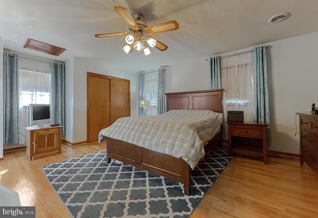 5425 Indian Head Hwy, Indian Head, MD 20640 - bedroom with a textured ceiling, light hardwood / wood-style floors, a closet, and ceiling fan