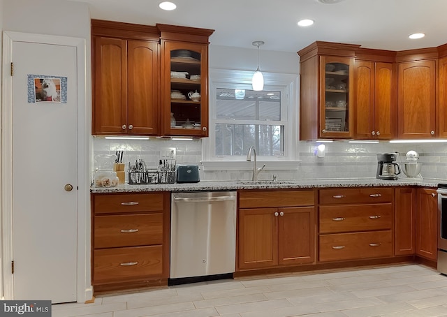5425 Indian Head Hwy, Indian Head, MD 20640 - kitchen featuring appliances with stainless steel finishes, pendant lighting, sink, decorative backsplash, and light stone countertops