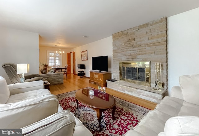 5425 Indian Head Hwy, Indian Head, MD 20640 - living room featuring wood-type flooring, a stone fireplace, and an inviting chandelier