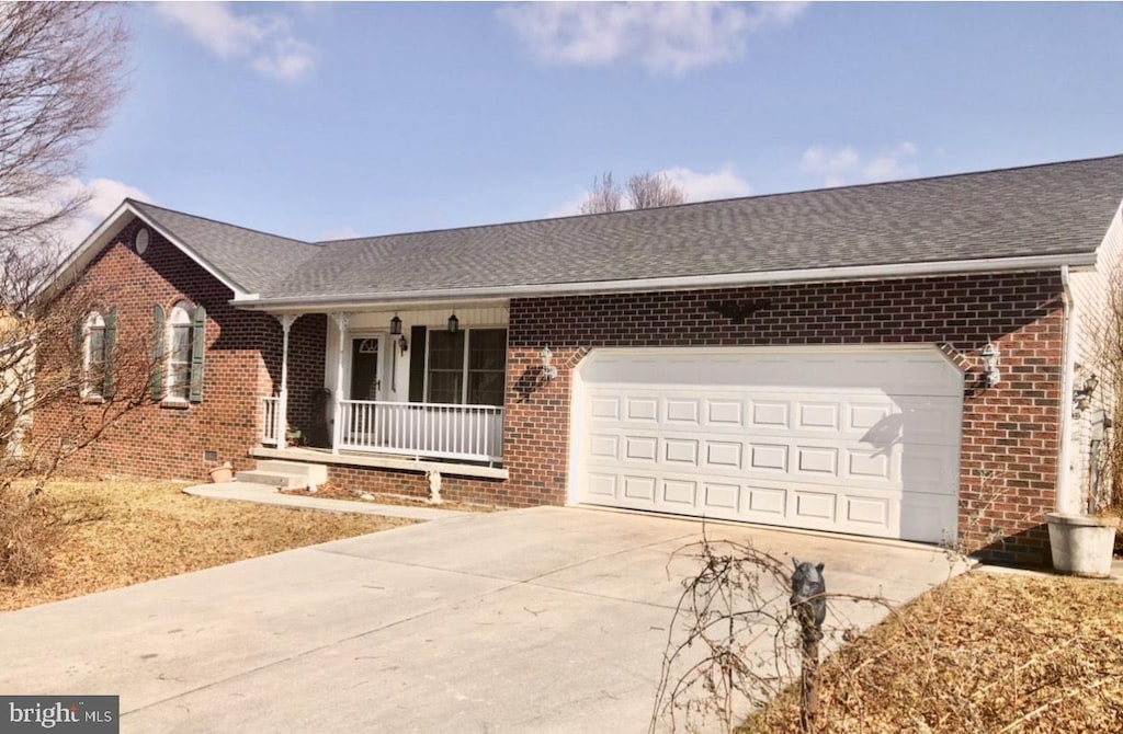 single story home featuring a garage and covered porch