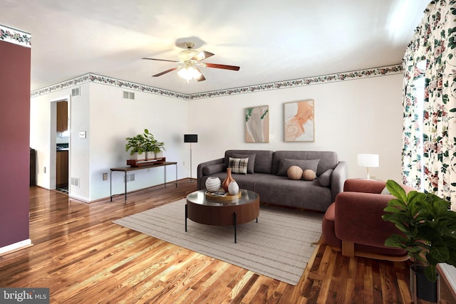 living area with visible vents, ceiling fan, and wood finished floors