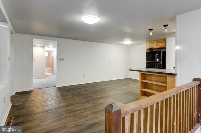 unfurnished living room with dark hardwood / wood-style floors