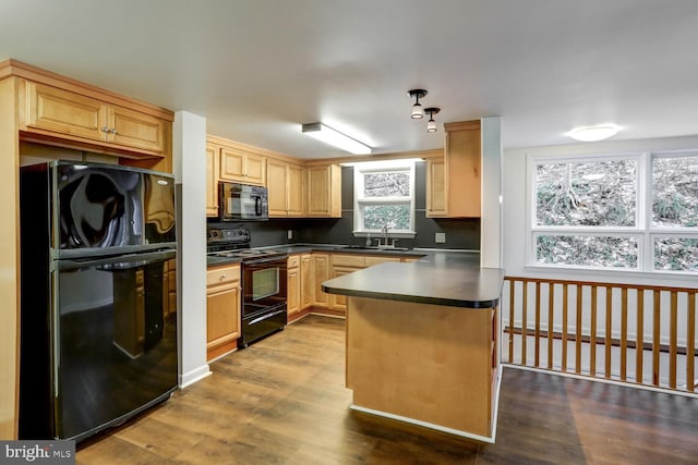 kitchen with dark hardwood / wood-style flooring, sink, black appliances, and light brown cabinets