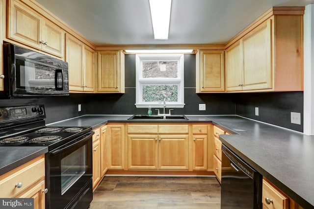 kitchen featuring sink, dark wood-type flooring, and black appliances