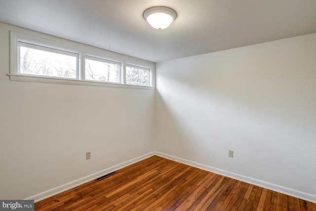 spare room featuring wood-type flooring