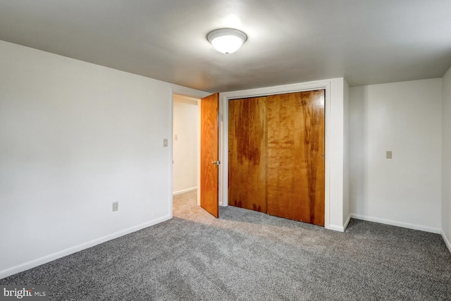 unfurnished bedroom with carpet floors and a closet