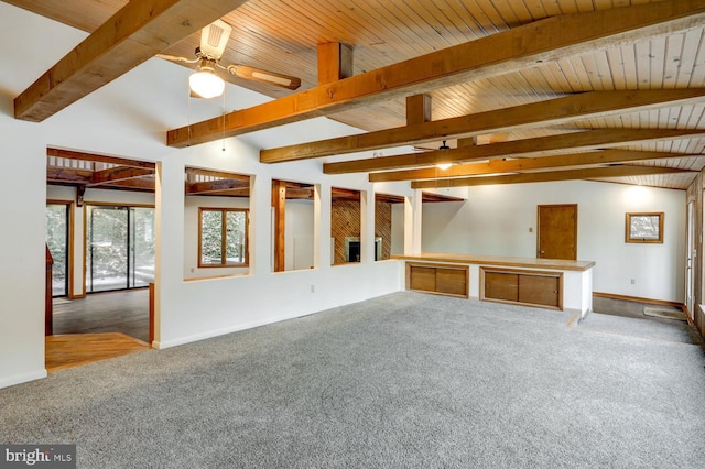 carpeted spare room featuring ceiling fan, wooden ceiling, and beam ceiling