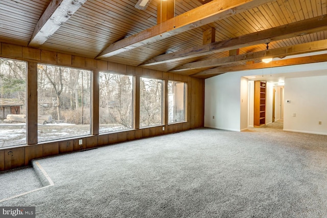 unfurnished sunroom featuring lofted ceiling with beams