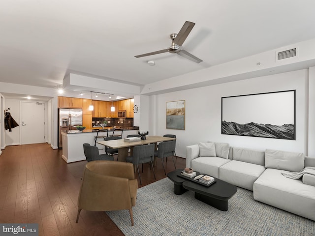 living room with hardwood / wood-style floors and ceiling fan