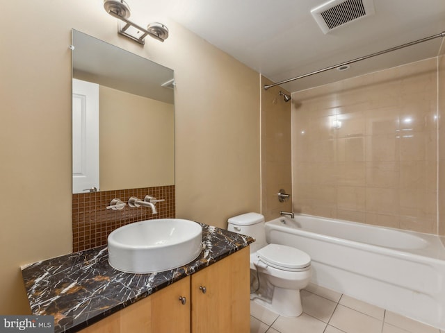 full bathroom with tasteful backsplash, tiled shower / bath combo, vanity, toilet, and tile patterned floors