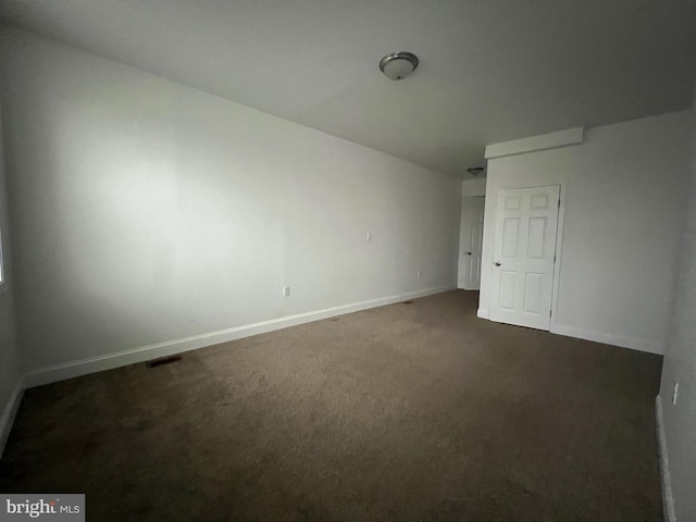 unfurnished bedroom featuring dark colored carpet