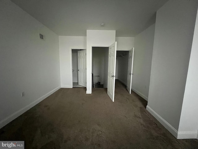 unfurnished bedroom featuring dark carpet