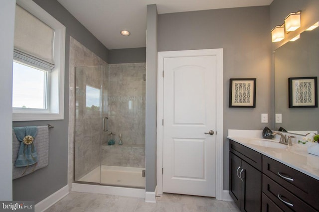 bathroom featuring vanity and a shower with door