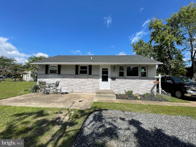 single story home with a patio and a front lawn