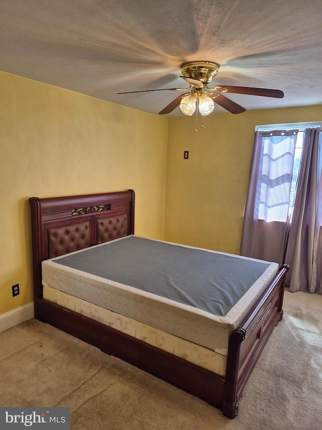 bedroom featuring light carpet and ceiling fan