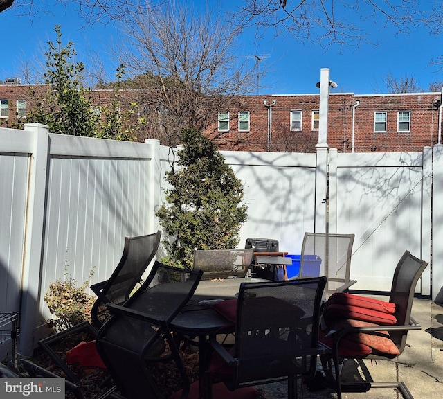 view of patio / terrace with outdoor dining area and fence