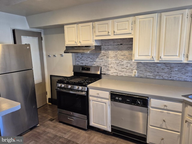 kitchen with light countertops, backsplash, appliances with stainless steel finishes, white cabinetry, and under cabinet range hood