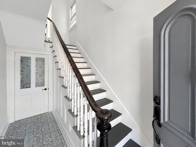 tiled foyer entrance featuring baseboards