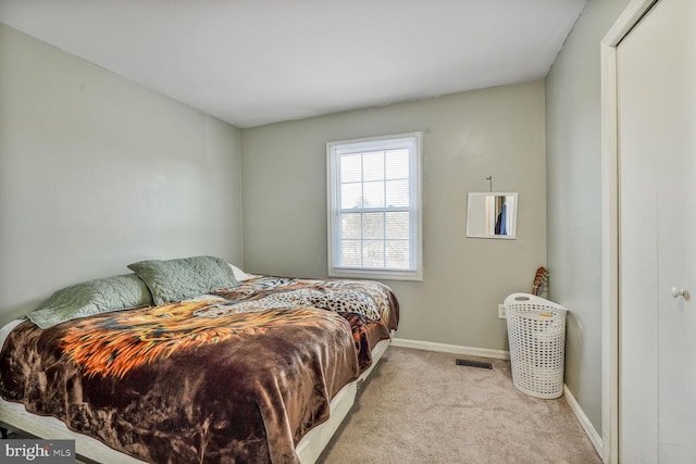 bedroom with baseboards, visible vents, and carpet floors