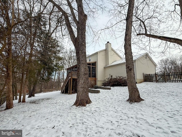 snow covered property with a deck