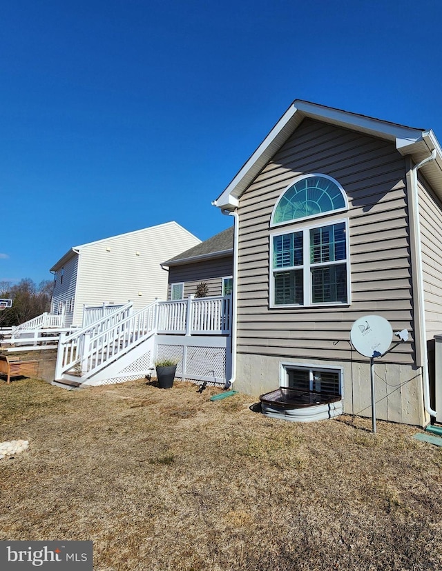 rear view of property with a yard and a deck