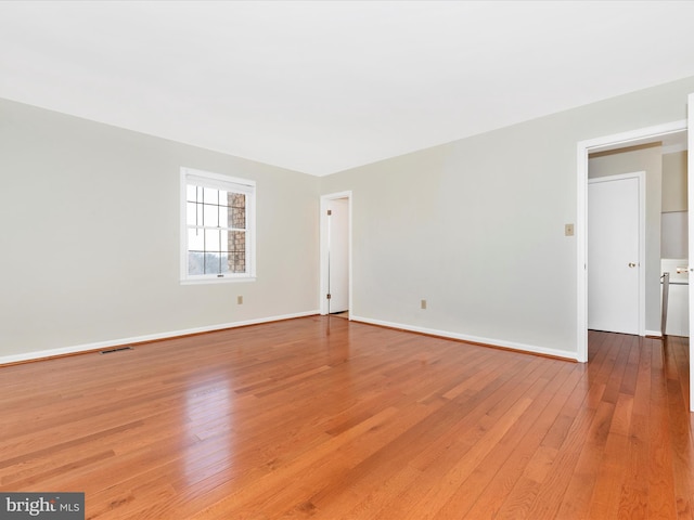 empty room with hardwood / wood-style flooring