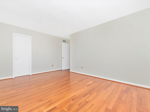 spare room featuring light hardwood / wood-style flooring