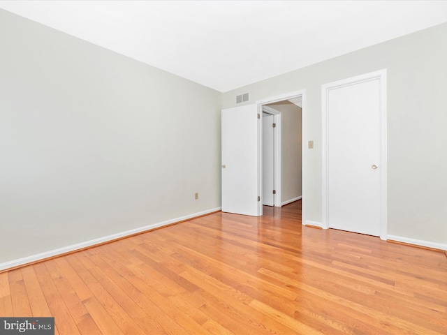 spare room featuring light hardwood / wood-style flooring