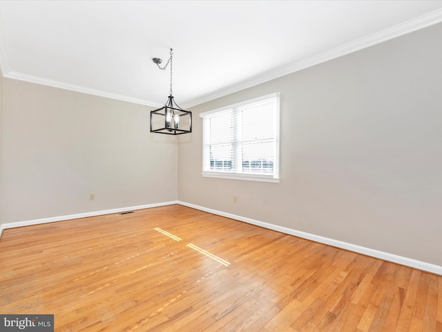 unfurnished dining area featuring a notable chandelier, light hardwood / wood-style floors, and ornamental molding