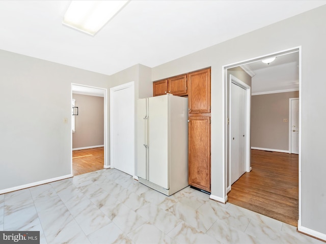 unfurnished bedroom featuring crown molding and white refrigerator