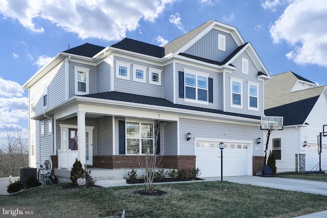 view of front of house featuring a garage, a porch, a front yard, and a wall unit AC