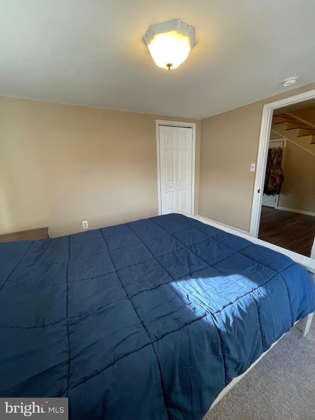 unfurnished bedroom featuring wood-type flooring and a closet