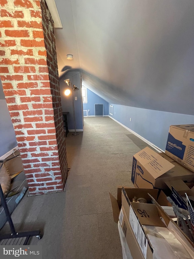 bonus room featuring vaulted ceiling and carpet