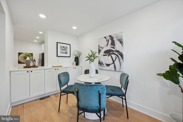 dining area featuring light wood-type flooring