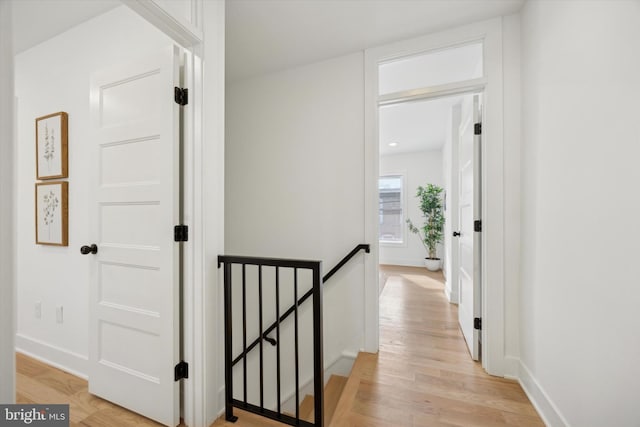 corridor with light hardwood / wood-style floors