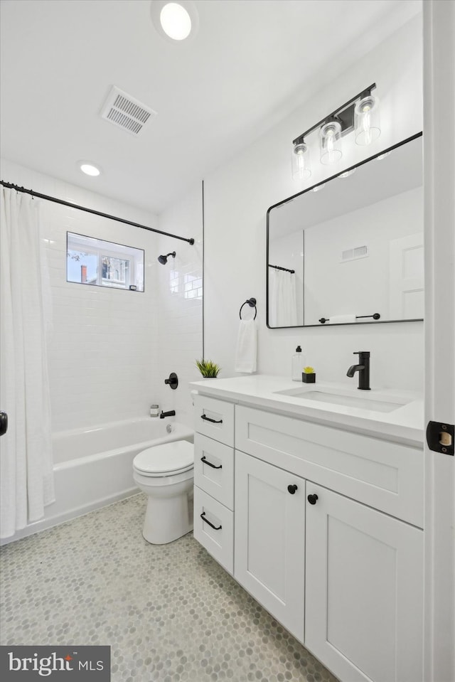 full bathroom with vanity, shower / tub combo, and toilet