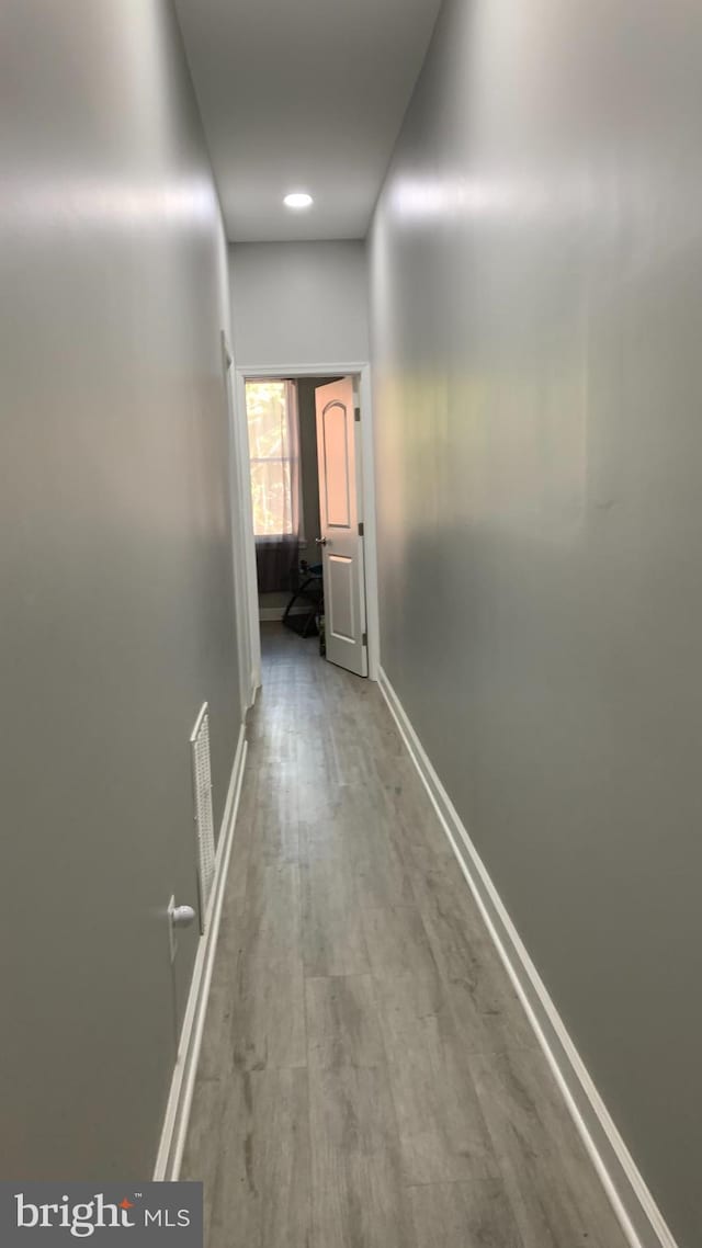 corridor featuring hardwood / wood-style floors