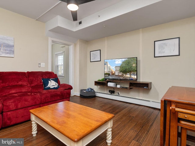 living room featuring dark wood-type flooring and a baseboard radiator