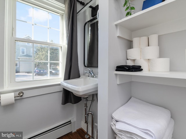 spacious closet featuring a baseboard heating unit