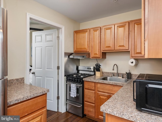 kitchen with sink, dark hardwood / wood-style floors, and stainless steel gas stove